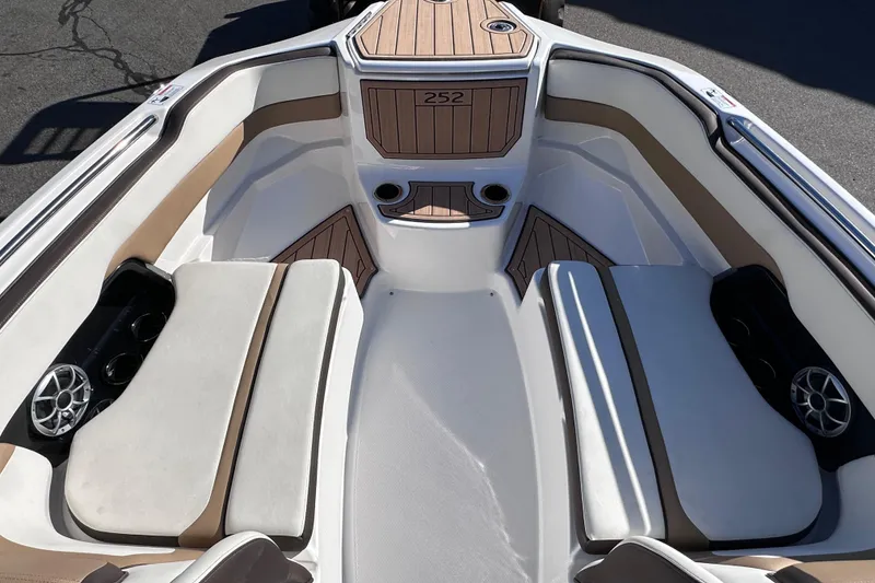 Slide: The Image of 2021 Yamaha Boats 252SD interior with cushioned seating and cup holders. - 35