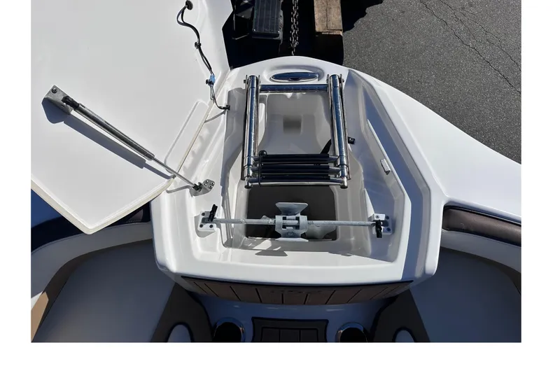 Slide: The Image of 2021 Yamaha Boats 252SD anchor compartment with ladder and hatch open. - 36