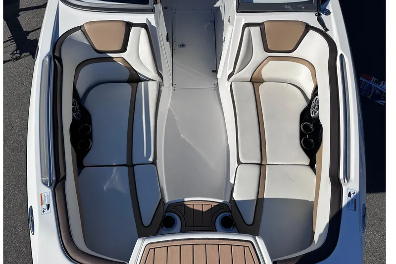 Slide: The Image of 2021 Yamaha Boats 252SD interior with beige and white seating, cup holders, and speakers. - 37
