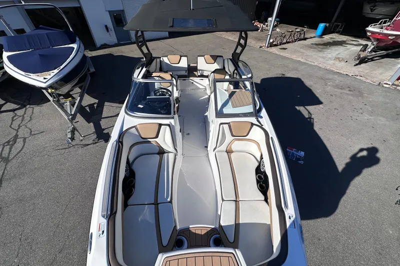 Slide: The Image of 2021 Yamaha Boats 252SD with spacious seating and sleek design, parked outdoors. - 38
