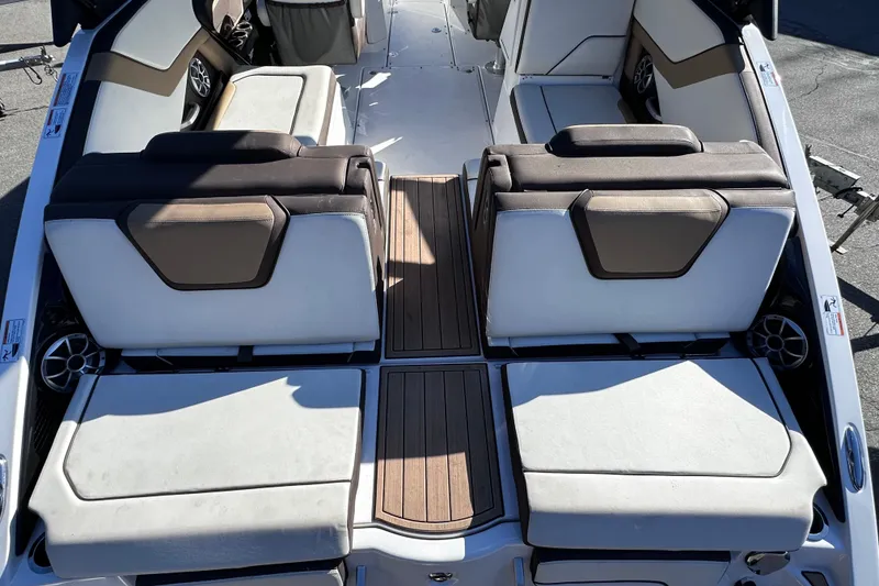 Slide: The Image of 2021 Yamaha Boats 252SD interior with cushioned seating and wood accents. - 9