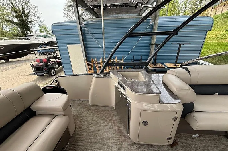 Slide: The Image of Interior of a 2017 Avalon Ambassador Elite Windshield boat with seating and sink. - 10