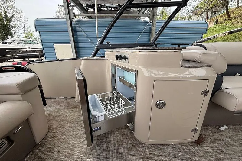 Slide: The Image of 2017 Avalon Ambassador Elite Windshield boat interior with open storage compartment. - 12