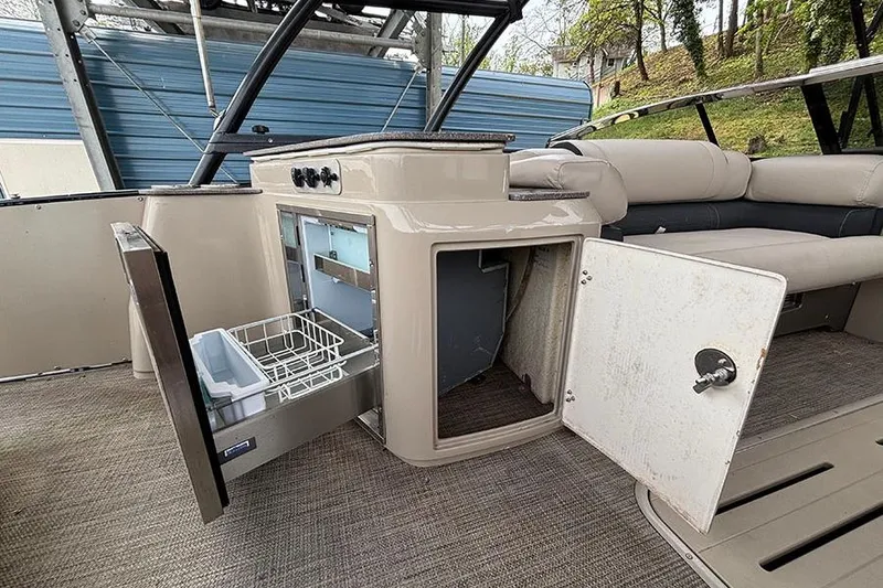Slide: The Image of 2017 Avalon Ambassador Elite Windshield boat interior with open storage compartments. - 13