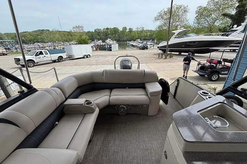 Slide: The Image of 2017 Avalon Ambassador Elite Windshield boat interior with seating and marina view. - 15