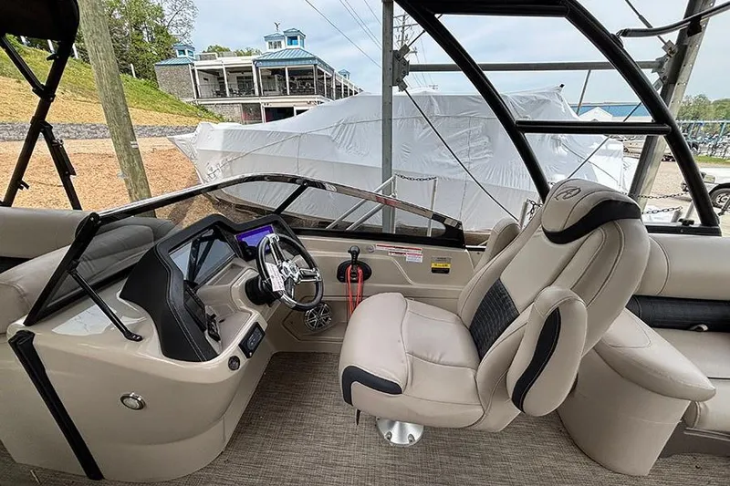 Slide: The Image of Interior of a 2017 Avalon Ambassador Elite Windshield boat, featuring a sleek helm and comfortable seating. - 18