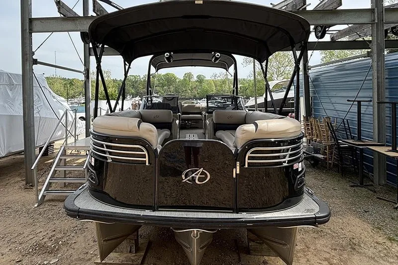 Slide: The Image of 2017 Avalon Ambassador Elite Windshield 27' pontoon boat docked outdoors. - 2