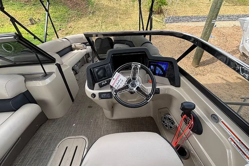 Slide: The Image of Interior view of 2017 Avalon Ambassador Elite Windshield boat, featuring steering wheel and seating. - 20