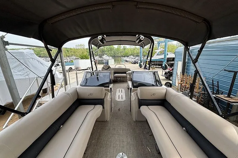 Slide: The Image of Interior view of 2017 Avalon Ambassador Elite Windshield 27' pontoon boat with seating and canopy. - 24
