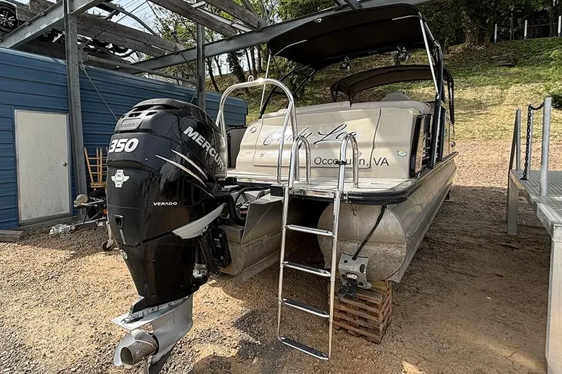 Slide: The Image of 2017 Avalon Ambassador Elite Windshield boat with Mercury 350 Verado engine, docked on land. - 4