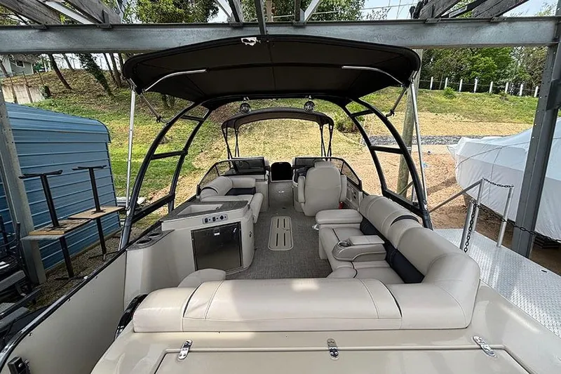 Slide: The Image of 2017 Avalon Ambassador Elite Windshield boat interior with beige seating and canopy. - 5