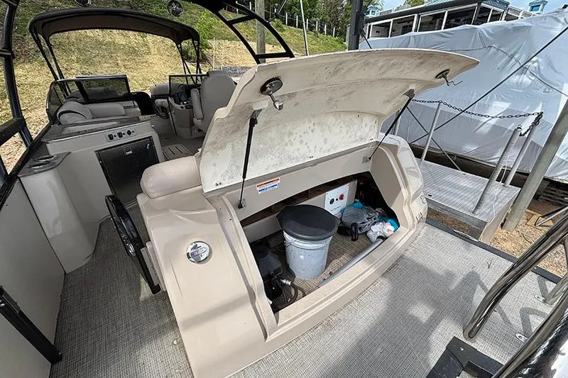 Slide: The Image of 2017 Avalon Ambassador Elite Windshield boat interior with open storage compartment. - 7
