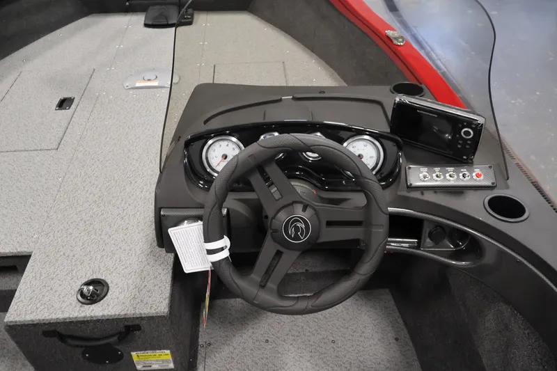 Slide: The Image of 2026 Crestliner 1650 HAWK SC boat dashboard with steering wheel and control panel. - 21