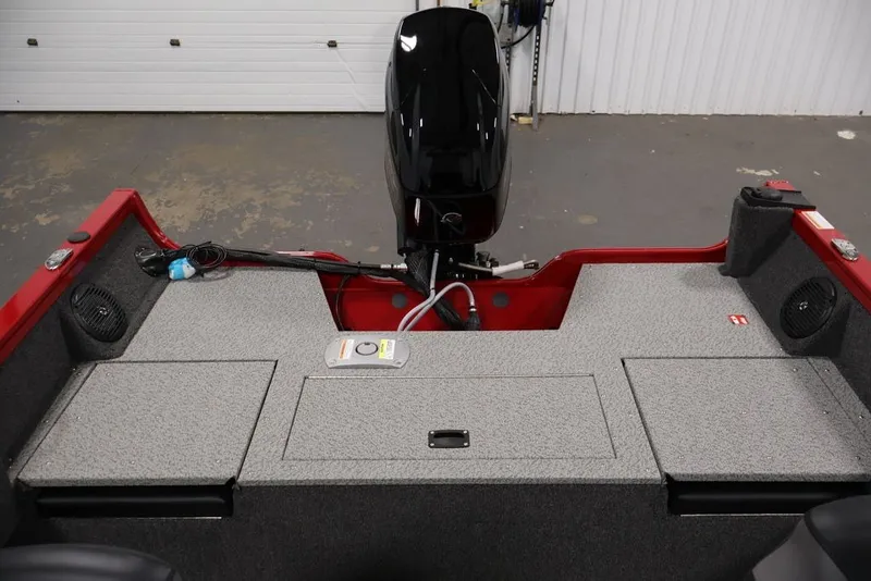 Slide: The Image of 2026 Crestliner 1650 Hawk SC boat interior with motor, storage compartments, and speakers. - 34