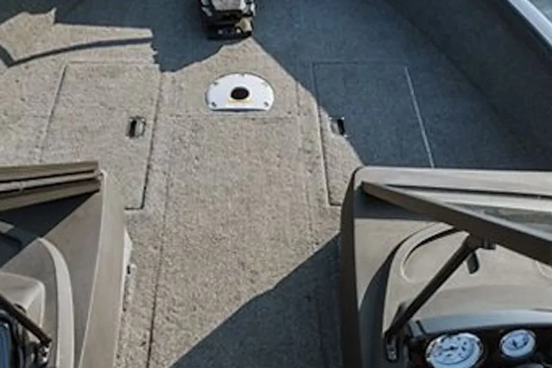 Slide: The Image of 2026 Crestliner 1650 Hawk SC boat interior with carpeted deck and control panel. - 41