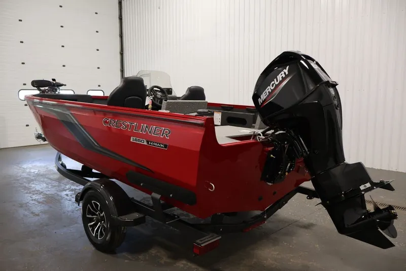 Slide: The Image of 2026 Crestliner 1650 Hawk SC boat with Mercury engine in a garage setting. - 8