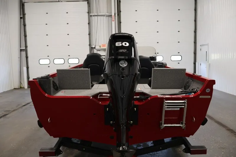 Slide: The Image of 2026 Crestliner 1650 Hawk SC boat with 60 HP motor in a garage setting. - 12