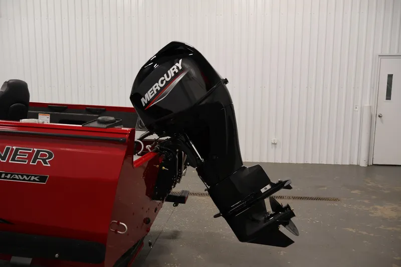 Slide: The Image of 2026 Crestliner 1650 HAWK SC boat with Mercury outboard motor in a showroom. - 32