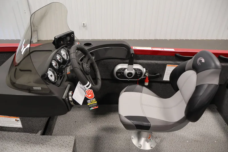 Slide: The Image of 2026 Crestliner 1650 HAWK SC boat interior with steering console and captain's chair. - 20