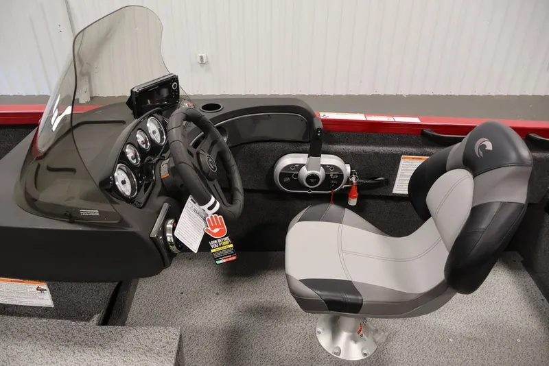 Slide: The Image of 2026 Crestliner 1650 Hawk SC boat interior with steering console and cushioned seat. - 23