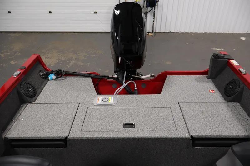 Slide: The Image of 2026 Crestliner 1650 HAWK SC boat interior with motor, red accents, and storage compartments. - 31