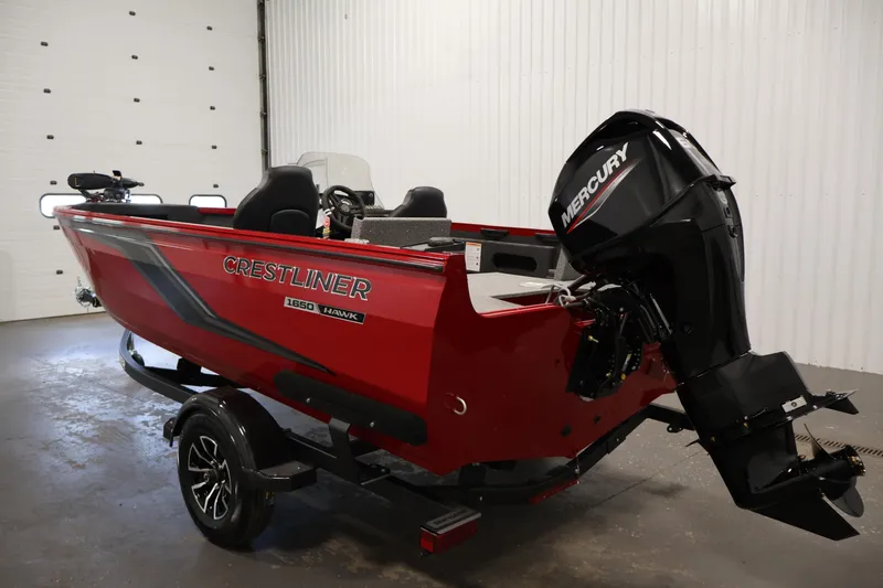 Slide: The Image of 2026 Crestliner 1650 HAWK SC boat with Mercury outboard motor in a garage. - 11