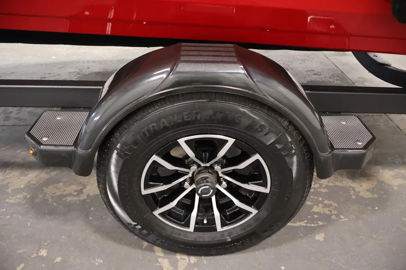Slide: The Image of Trailer wheel of 2026 Crestliner 1650 HAWK SC, featuring black alloy rims and sturdy fender. - 38