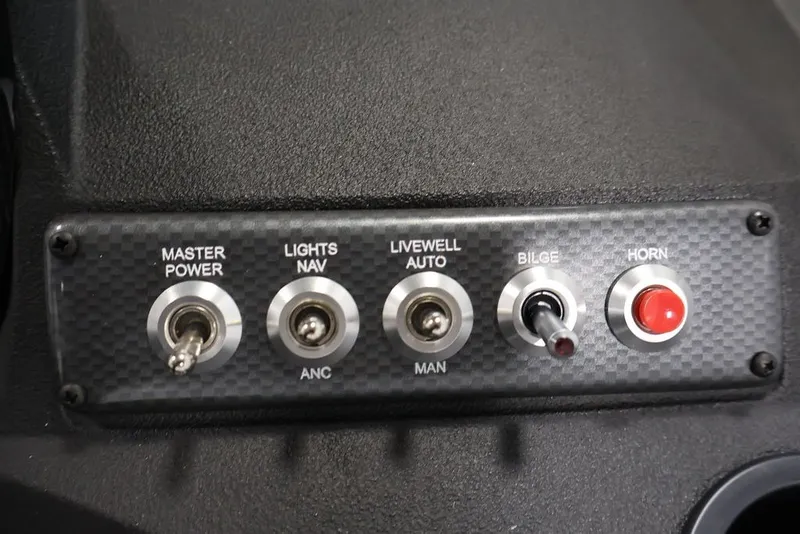 Slide: The Image of Control panel of 2026 Crestliner 1650 Hawk SC boat with switches and buttons. - 46