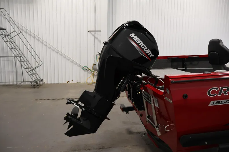 Slide: The Image of 2026 Crestliner 1650 HAWK SC boat with Mercury outboard motor in a garage. - 33