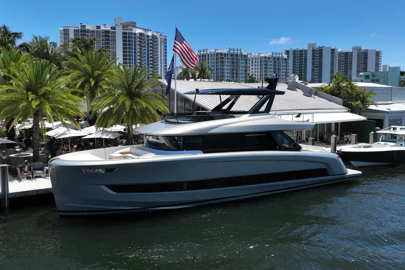 The Image of 2028 Solaris Power 70 Long Range yacht docked near palm trees and modern buildings. - 0