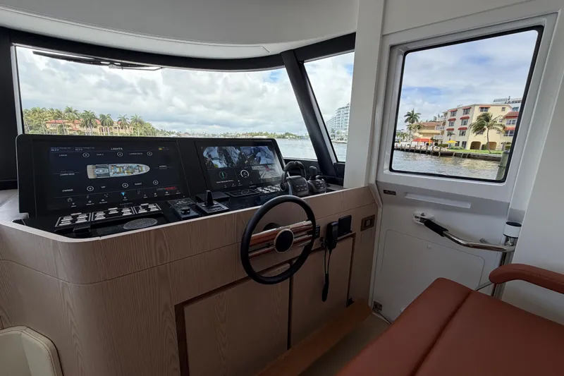 Slide: The Image of Cockpit of 2028 Solaris Power 70 Long Range yacht with modern navigation controls and waterfront view. - 22