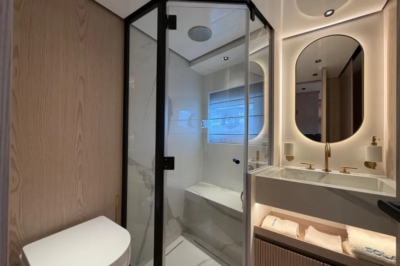 Slide: The Image of Luxurious bathroom in 2028 Solaris Power 70 Long Range yacht with modern fixtures and elegant design. - 26