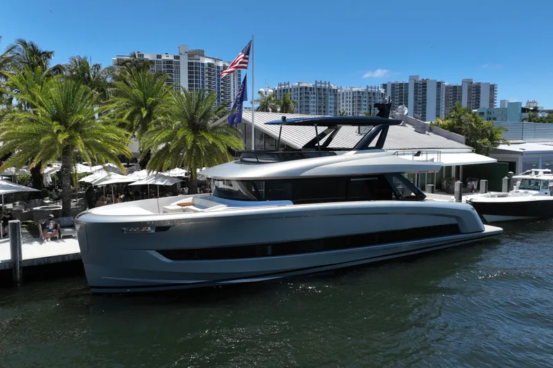 Slide: The Image of Luxurious 2028 Solaris Power 70 Long Range yacht docked by palm trees and modern buildings. - 3
