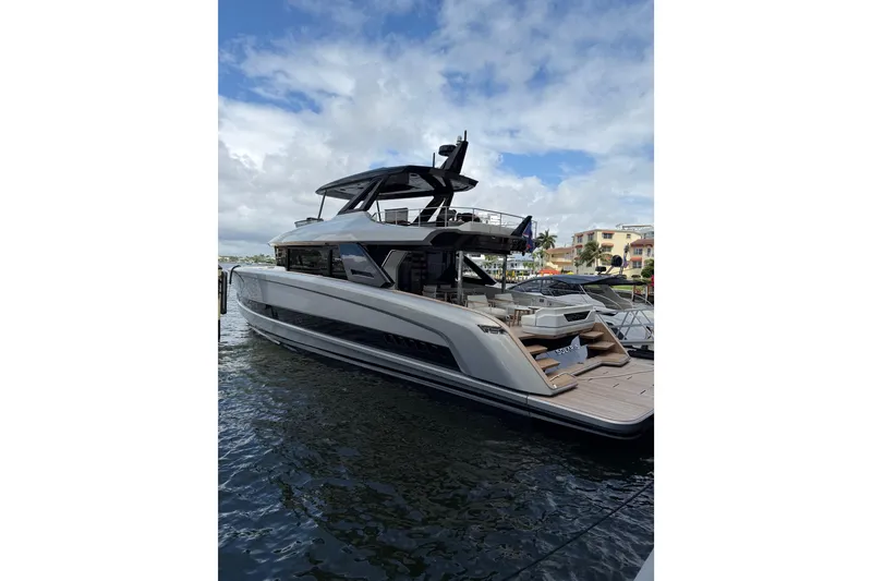 Slide: The Image of Luxury Solaris Power 70 Long Range yacht docked, 2028 model, sleek design under a partly cloudy sky. - 5