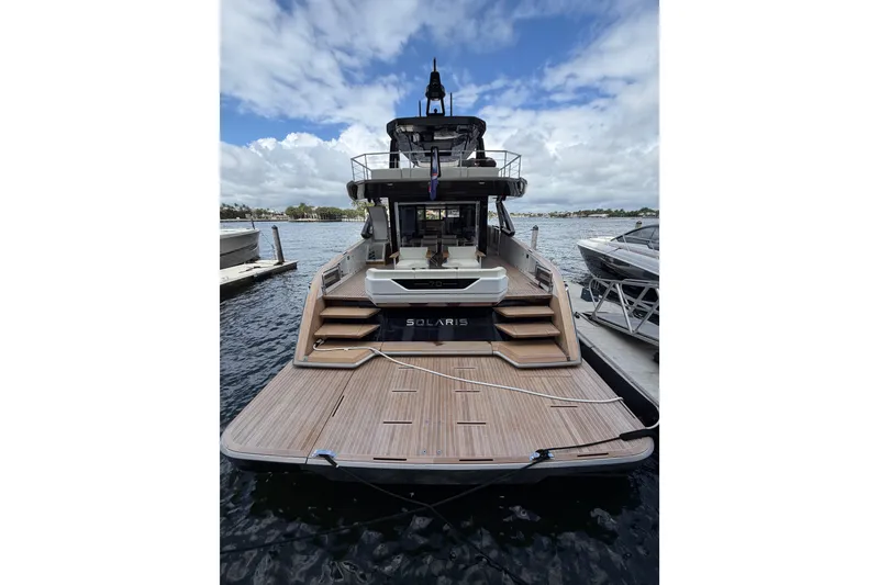 Slide: The Image of 2028 Solaris Power 70 Long Range yacht docked, showcasing elegant design and spacious deck. - 6