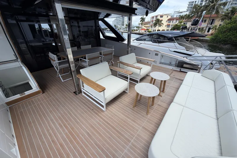 Slide: The Image of Luxurious deck of 2028 Solaris Power 70 Long Range yacht with elegant seating and tables. - 7