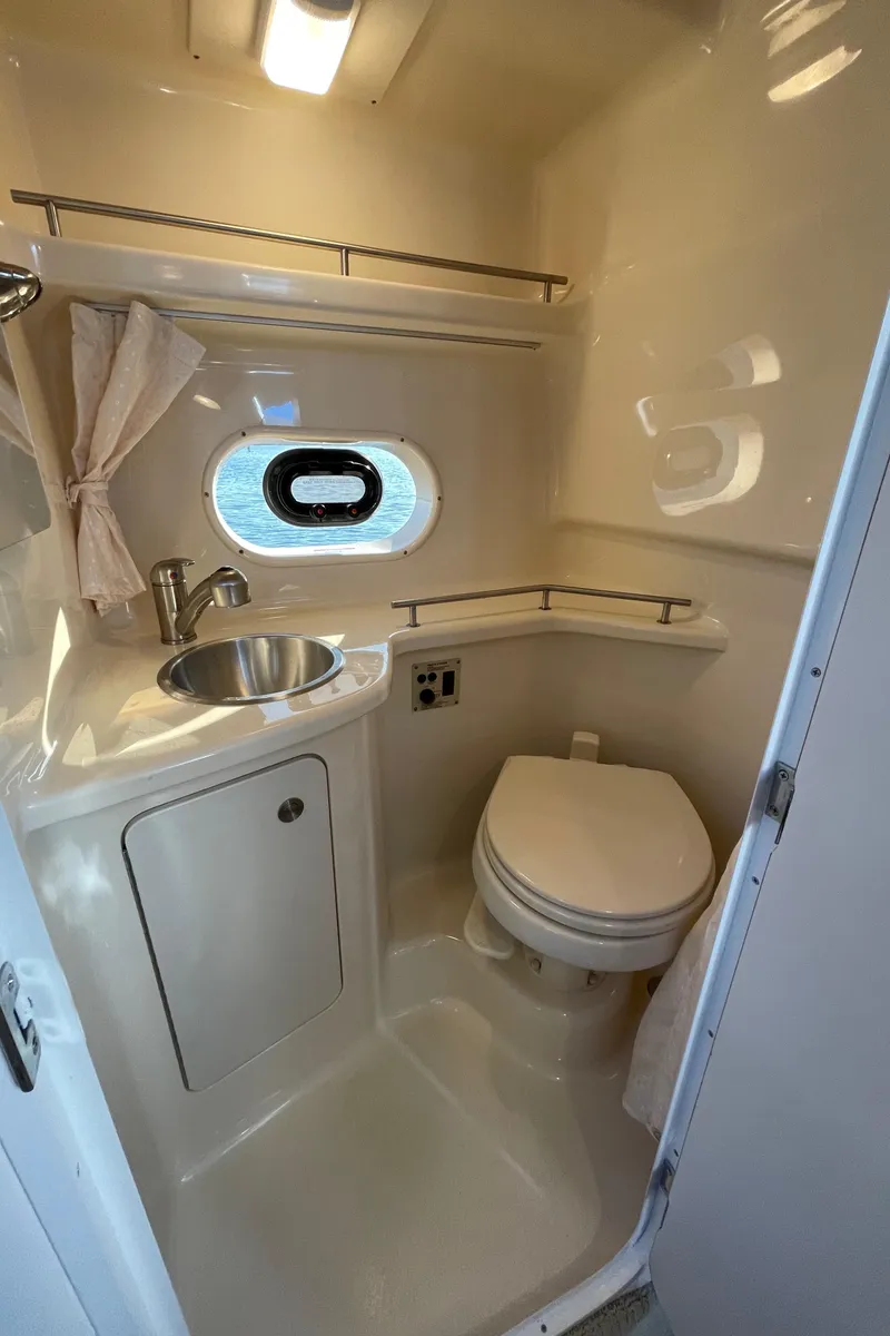 Slide: The Image of Sea Ray Sundancer 280 yacht interior, bathroom with sink and toilet. - 24