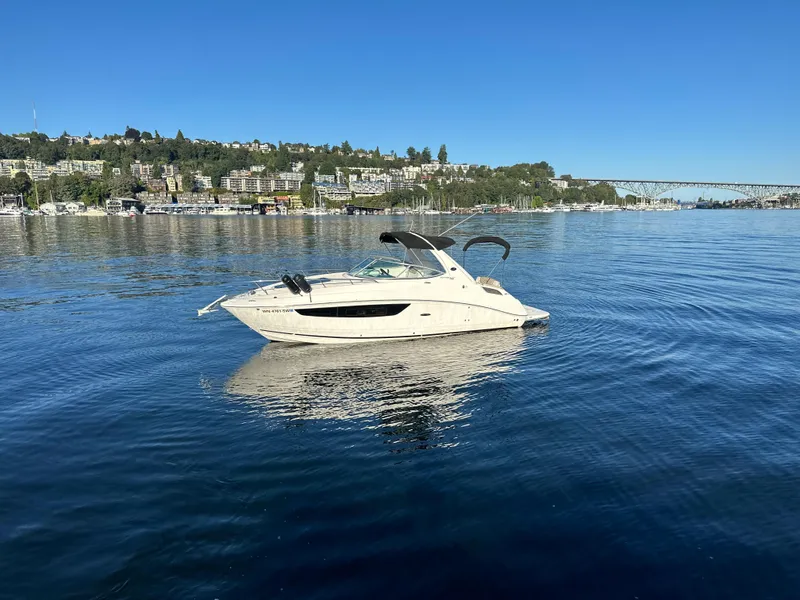 Slide: The Image of 2015 Sea Ray Sundancer 280 on calm water near coastal town. - 3