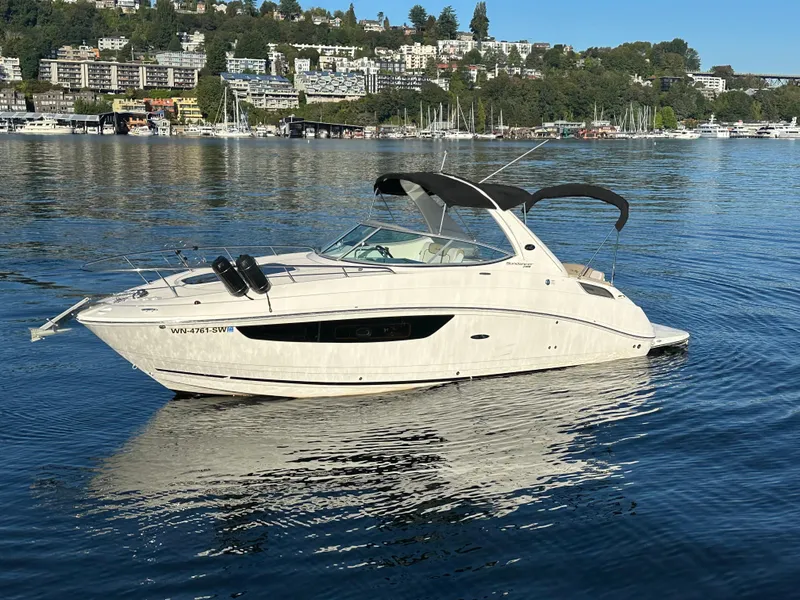 Slide: The Image of 2015 Sea Ray Sundancer 280 on calm water with cityscape background. - 37