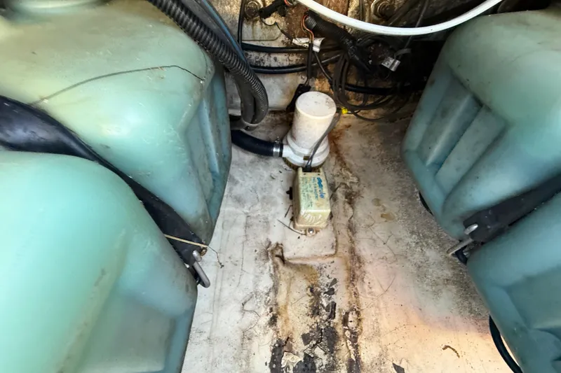 Slide: The Image of Engine compartment of a 2000 Sport-Craft 241 Walk Around boat, showing fuel tanks and wiring. - 103