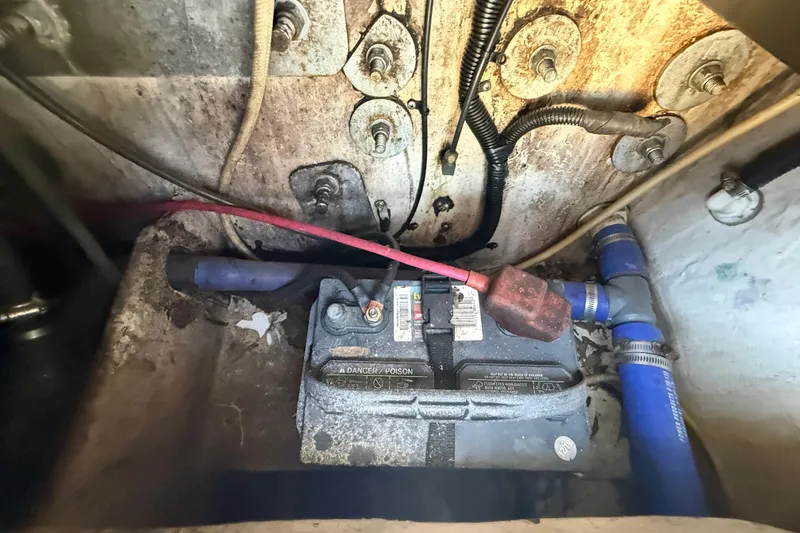 Slide: The Image of Battery compartment of a 2000 Sport-Craft 241 Walk Around boat, showing wiring and connections. - 107