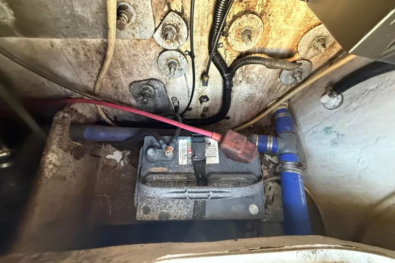 Slide: The Image of Battery compartment of a 2000 Sport-Craft 241 Walk Around boat, showing wiring and connections. - 108