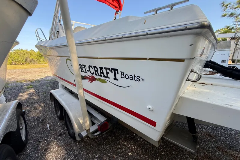 Slide: The Image of 2000 Sport-Craft 241 Walk Around boat on trailer, side view with logo visible. - 19