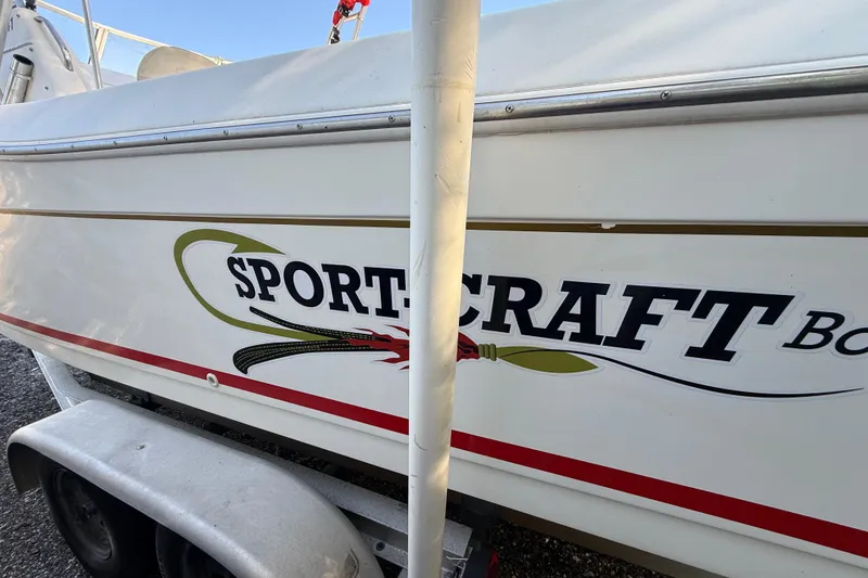 Slide: The Image of 2000 Sport-Craft 241 Walk Around boat on trailer, side view with logo. - 21