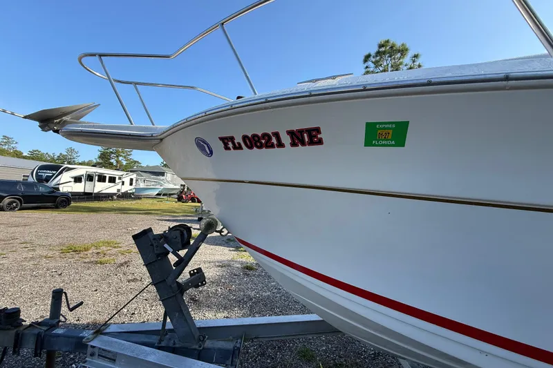 Slide: The Image of 2000 Sport-Craft 241 Walk Around boat on trailer, Florida registration visible. - 28