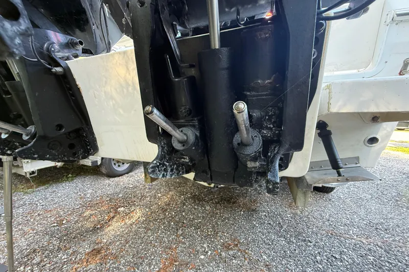 Slide: The Image of Outboard motor components of a 2000 Sport-Craft 241 Walk Around boat on gravel. - 32