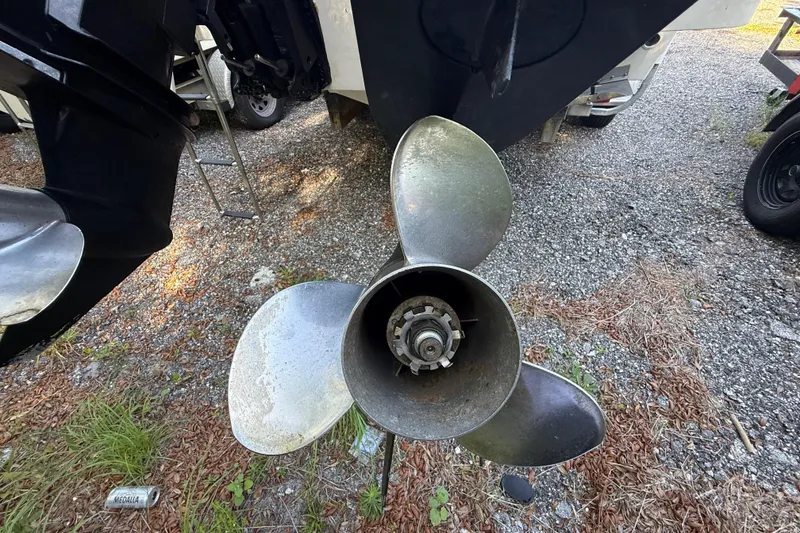 Slide: The Image of Propeller of a 2000 Sport-Craft 241 Walk Around boat on gravel surface. - 33