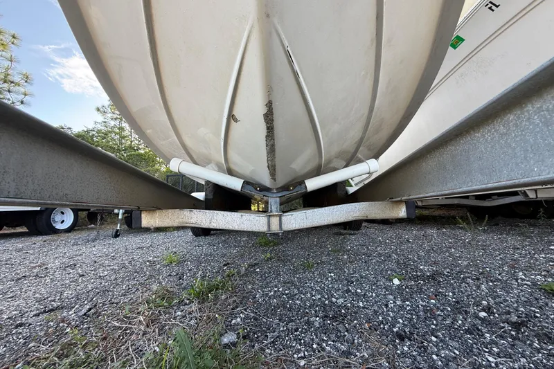 Slide: The Image of 2000 Sport-Craft 241 Walk Around boat on trailer, underside view, parked outdoors. - 34