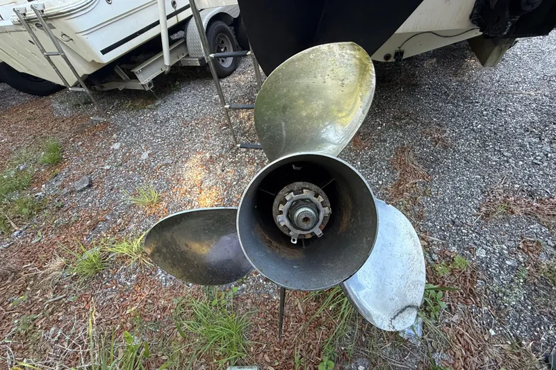 Slide: The Image of Propeller of a 2000 Sport-Craft 241 Walk Around boat on gravel surface. - 39