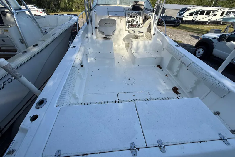 Slide: The Image of 2000 Sport-Craft 241 Walk Around boat interior, featuring spacious deck and seating area. - 42